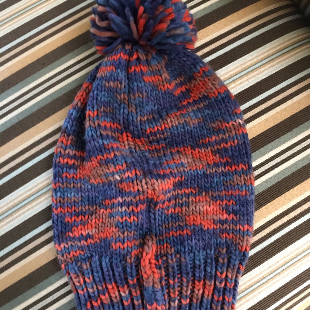 Multi colored beanie with poof top